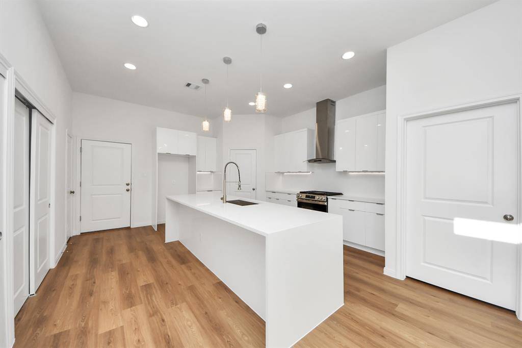 The kitchen features ceiling recessed LED lights.
