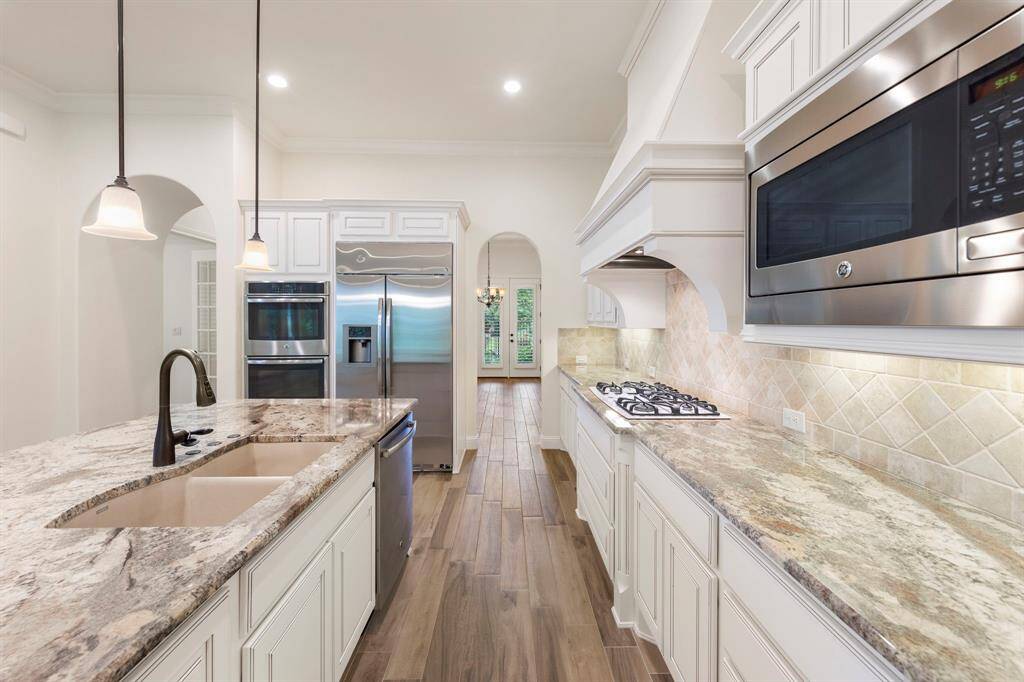 From the granite island with Blanco sink to the gas cooktop and built-in appliances, every detail of this kitchen is designed for both everyday ease and elevated entertaining.