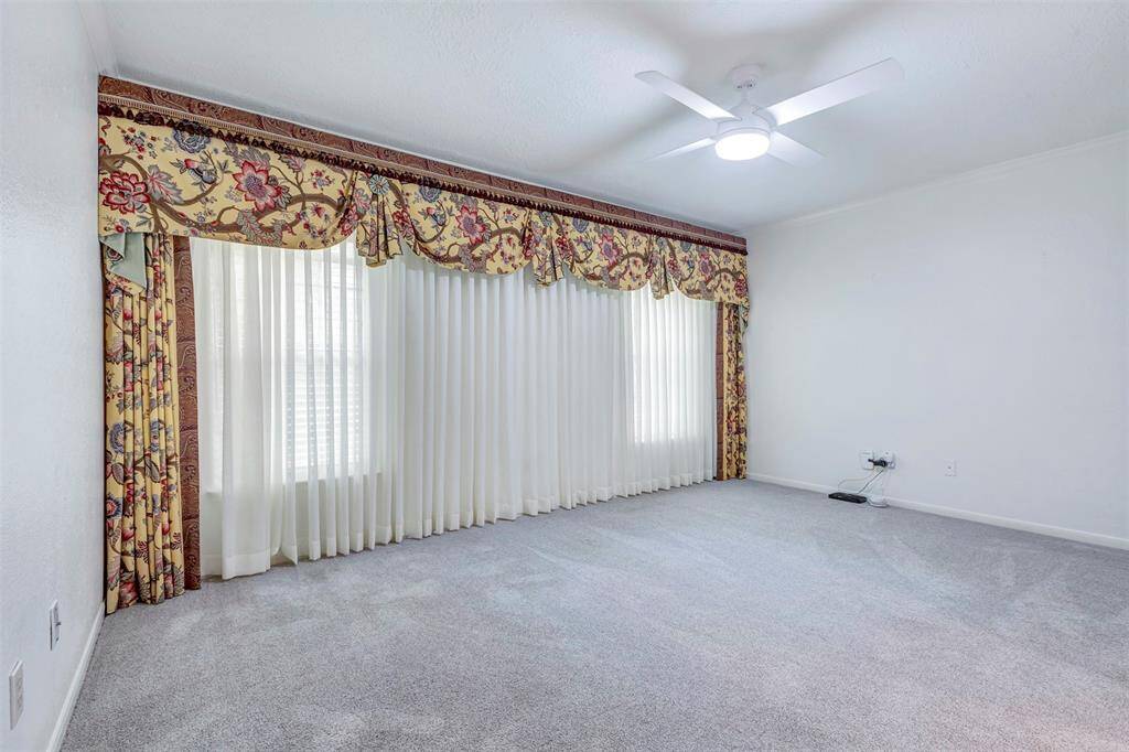 Experience luxury in the primary bedroom featuring elegant custom curtains and new pet protective backed plush carpet.