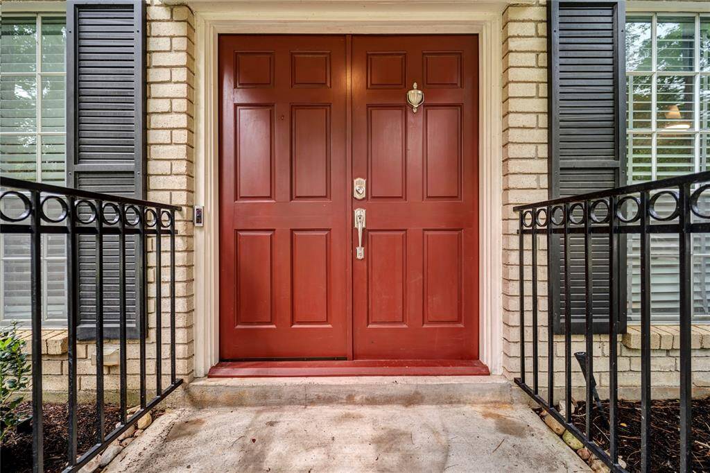 Double solid wood front doors with electronic lock.