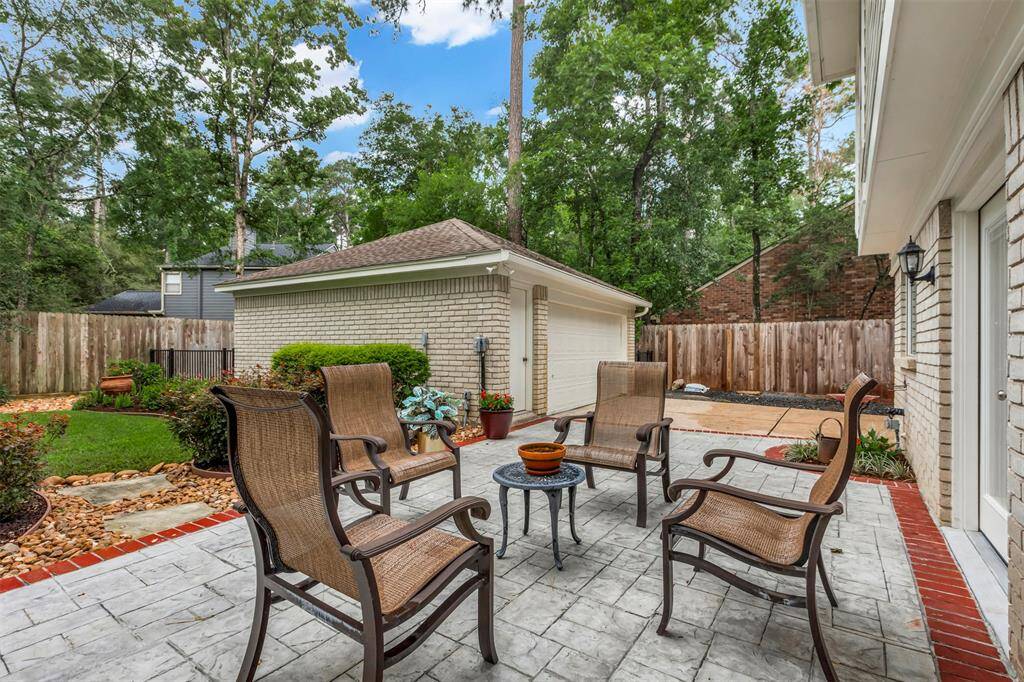 Charming patio with a spacious two-car detached garage, perfect for outdoor relaxation and convenient parking.
