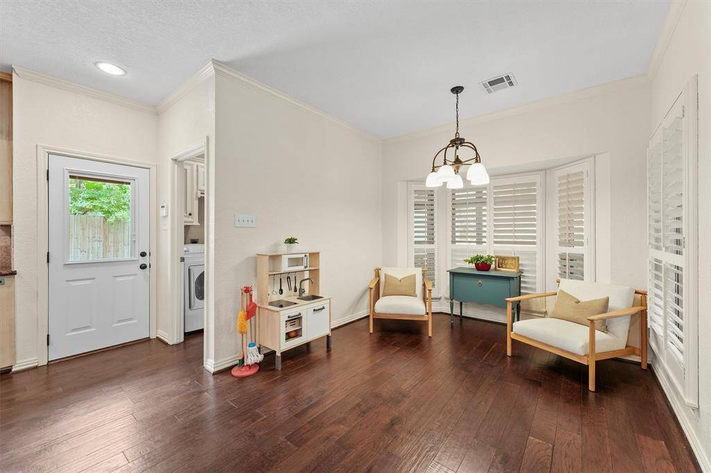 View of the breakfast room with the utility room and powder room to the left.
