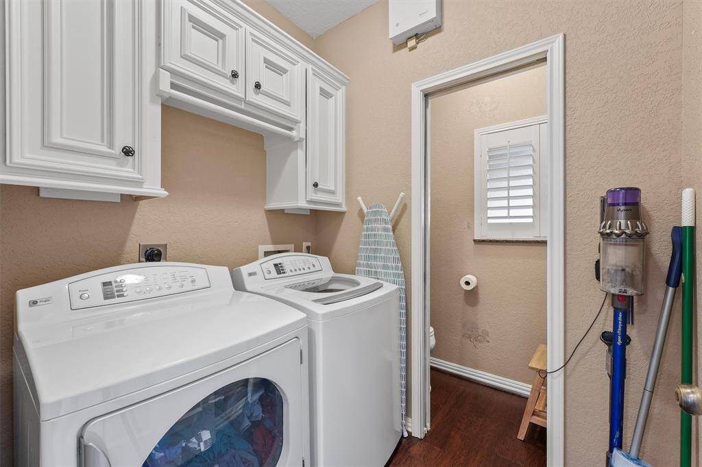 Laundry room with powder room.  Ample storage for cleaning supplies.