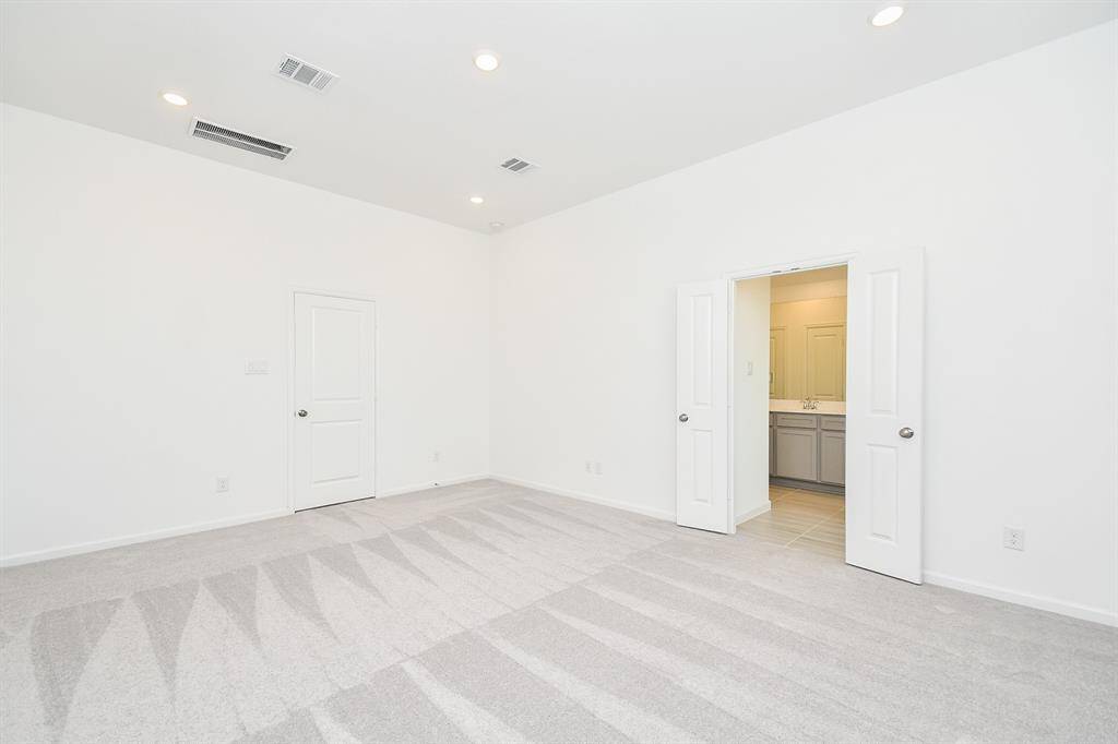 Primary bedroom with ensuite and walk in closet. Virtually staged photo