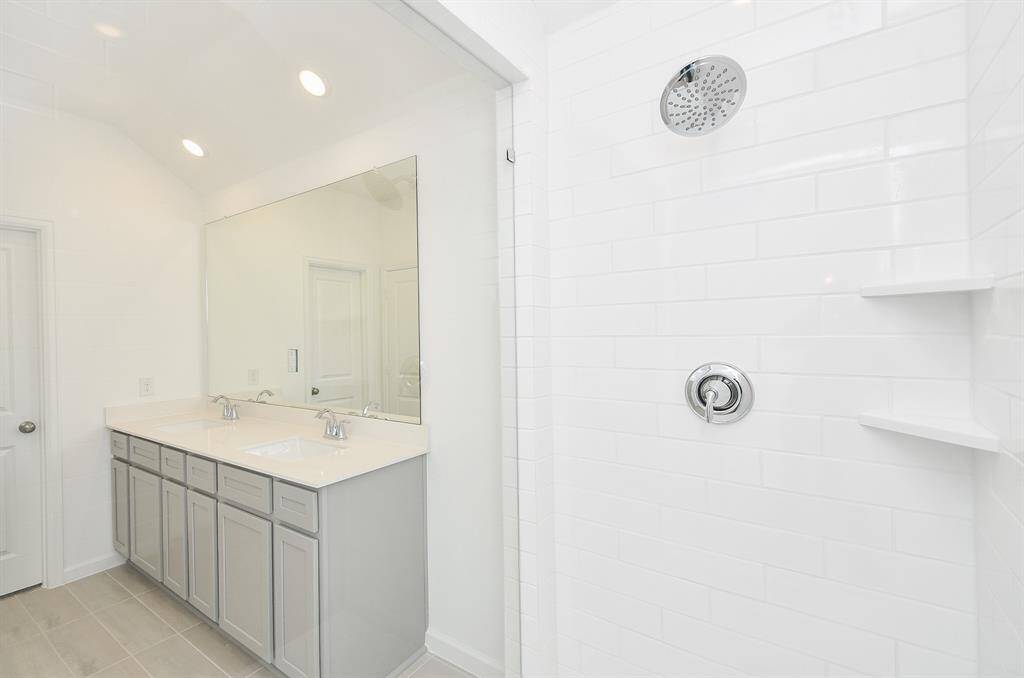 Primary en suite with double sinks, oversized shower and lots of storage.
