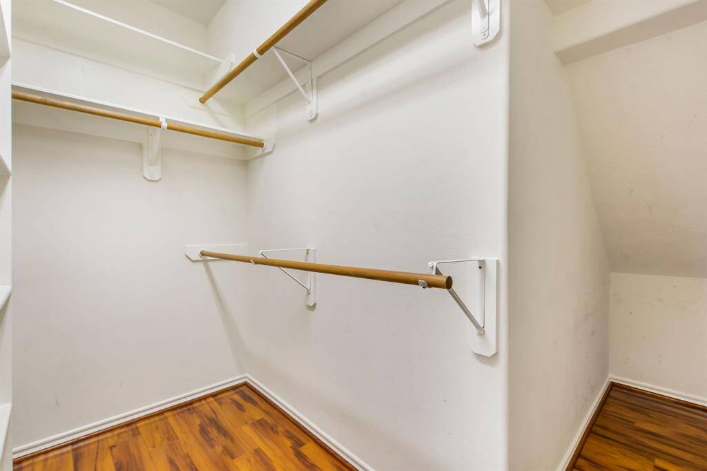 The primary bedroom closet ideally provides built-in shelving, hanging racks and nook for storage.