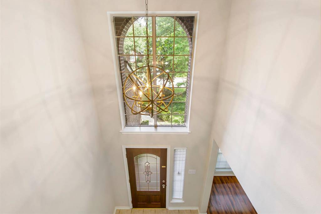 View from above the entry with soaring ceilings and updated lighting.