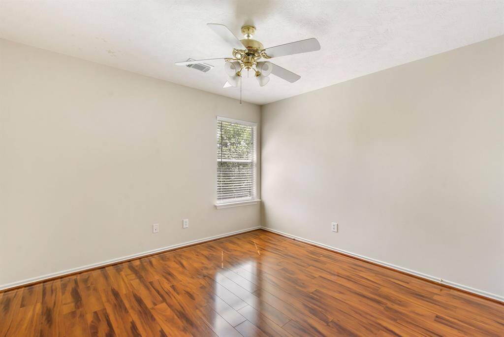 Secondary bedroom #2 has laminate wood floors, fresh paint and a ceiling fan.