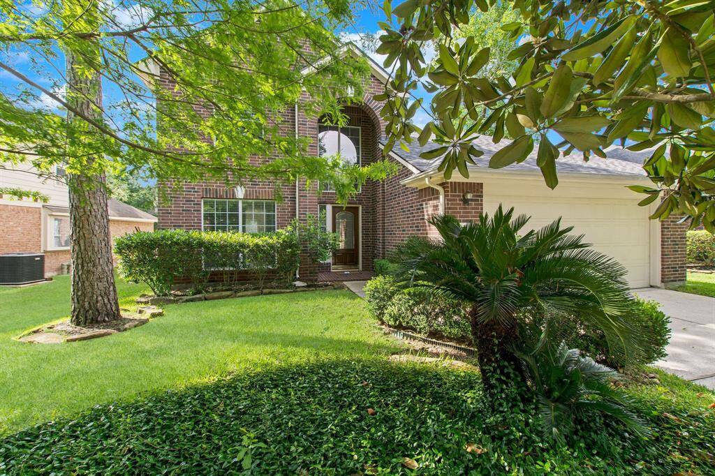 The home has stunning curb appeal with lush landscaping.