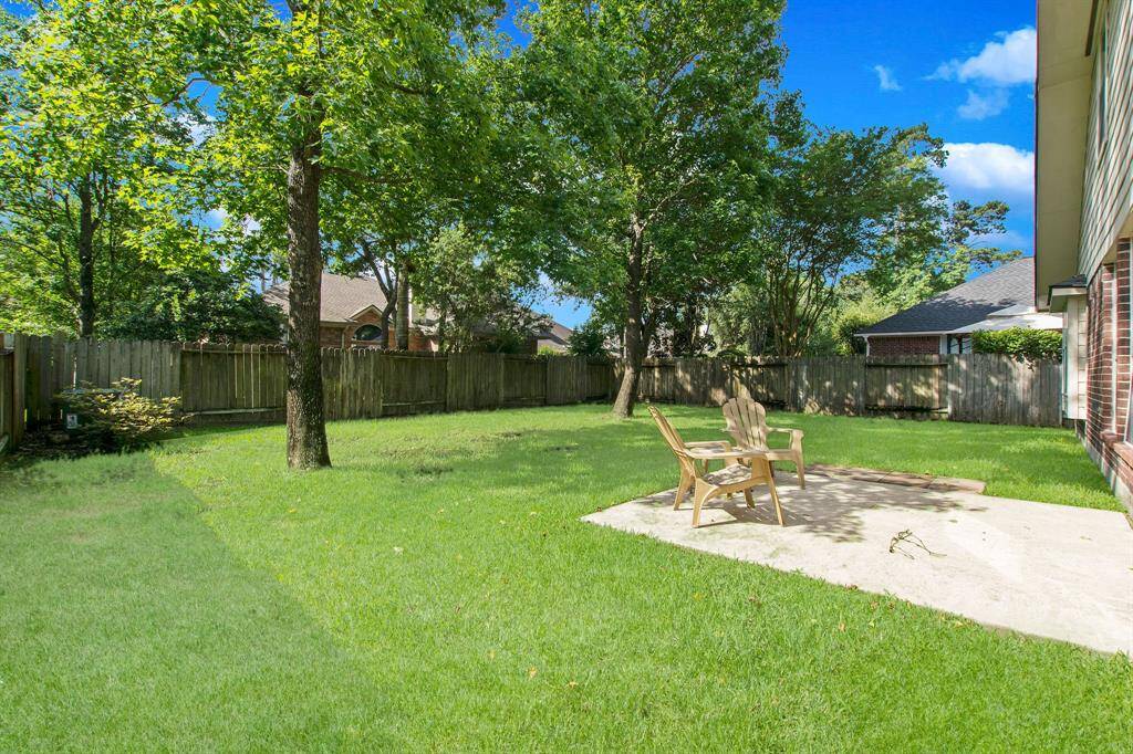 The large back yard area is fully fenced and features an open patio.