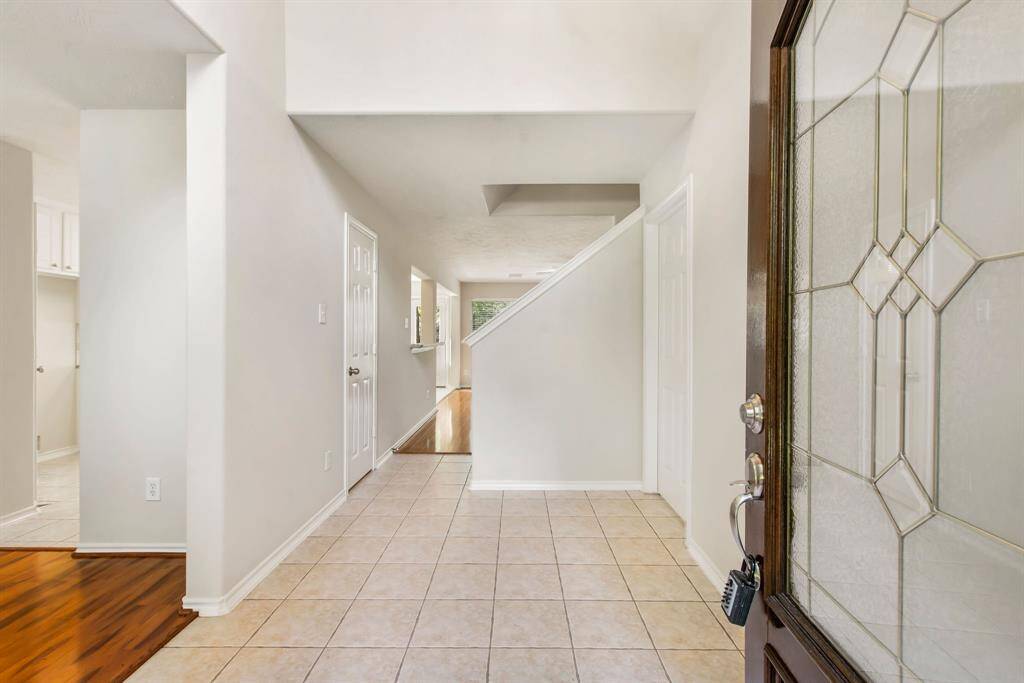 The entry presents tile flooring and bright neutral paint.