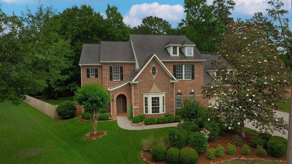 Stately brick home on over a half acre greenbelt lot in Sterling Ridge.