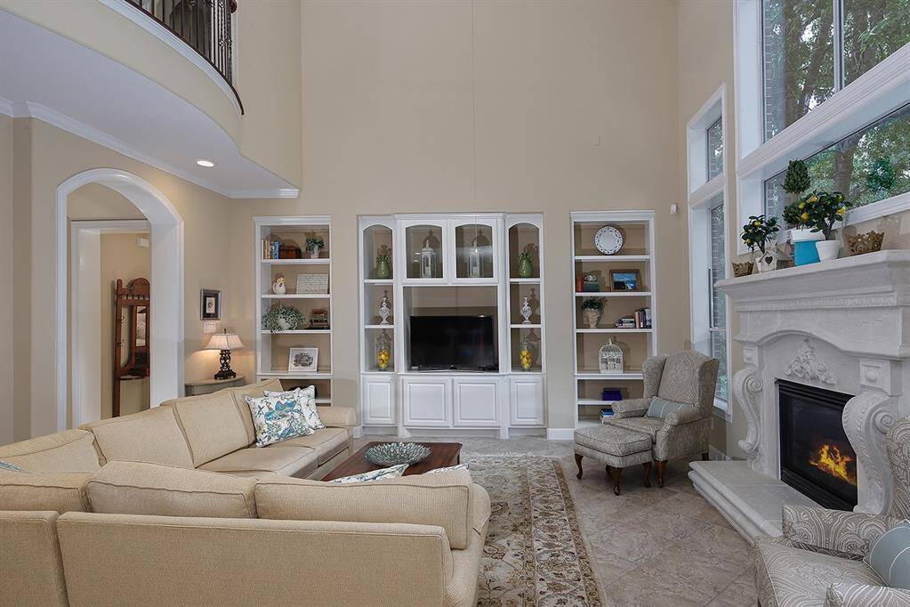 Fantastic built-in shelving, comfortable seating area, and fireplace create an inviting atmosphere.