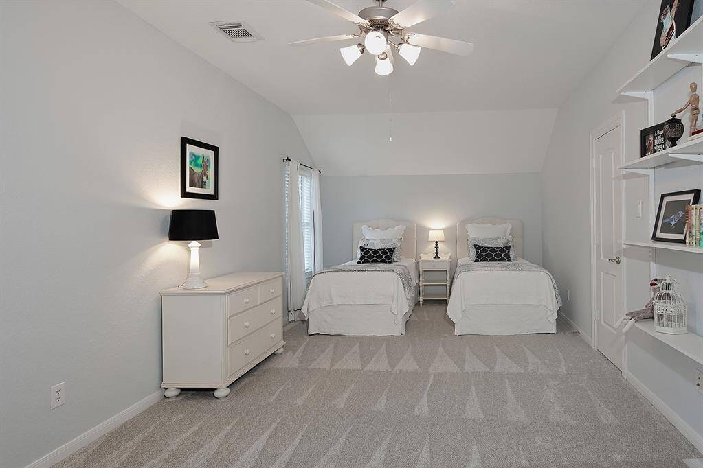 Bright and spacious bedroom with room for two twin beds and more.