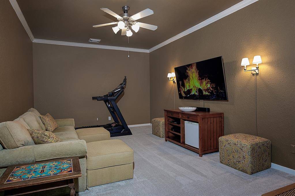 The media room features plenty of space for cozy furnishings for the whole family to enjoy movie night.