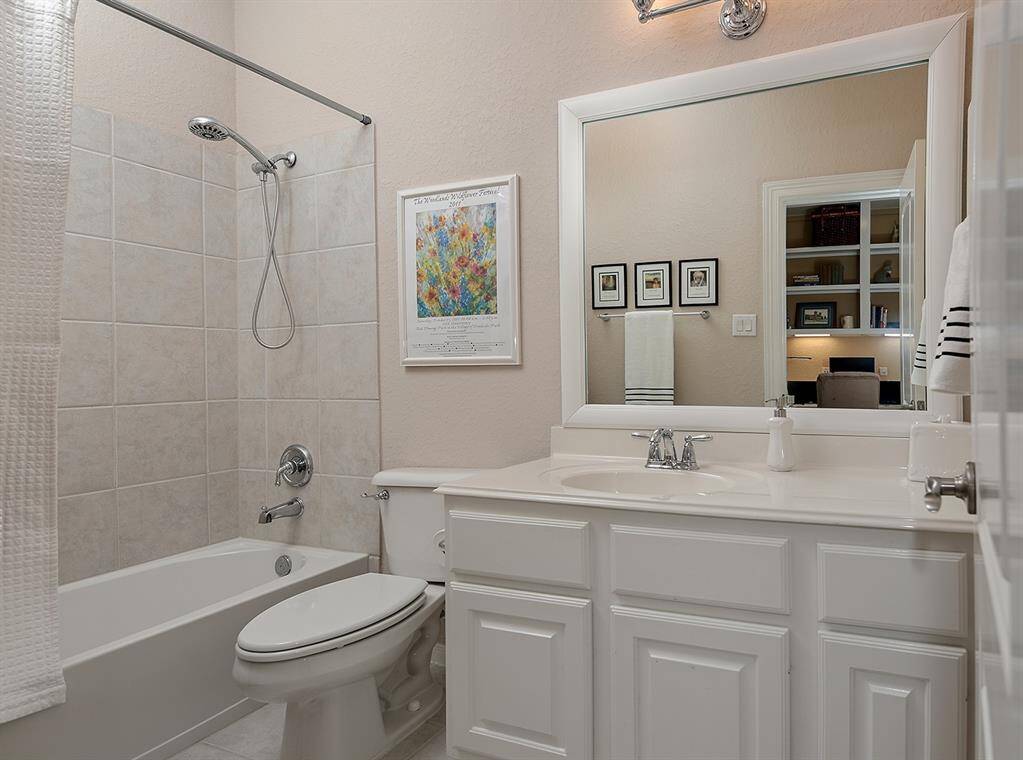 This bathroom is light and bright with white cabinets and countertop.