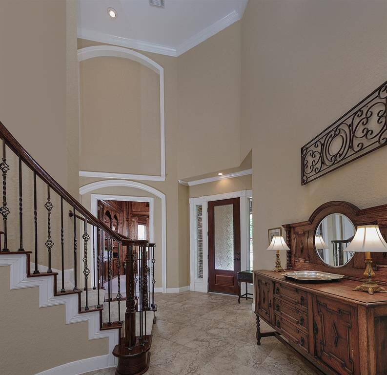 Open entryway has a statement staircase with beautiful views to the family room and upstairs. Halfway up stairs is a convenient shortcut to the kitchen area.