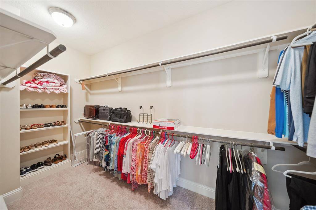 Wowza! Talk about space! This walk-in closet has plenty of room for all your clothes, and then some. Built in shelves and shoe racks are lovely additions.