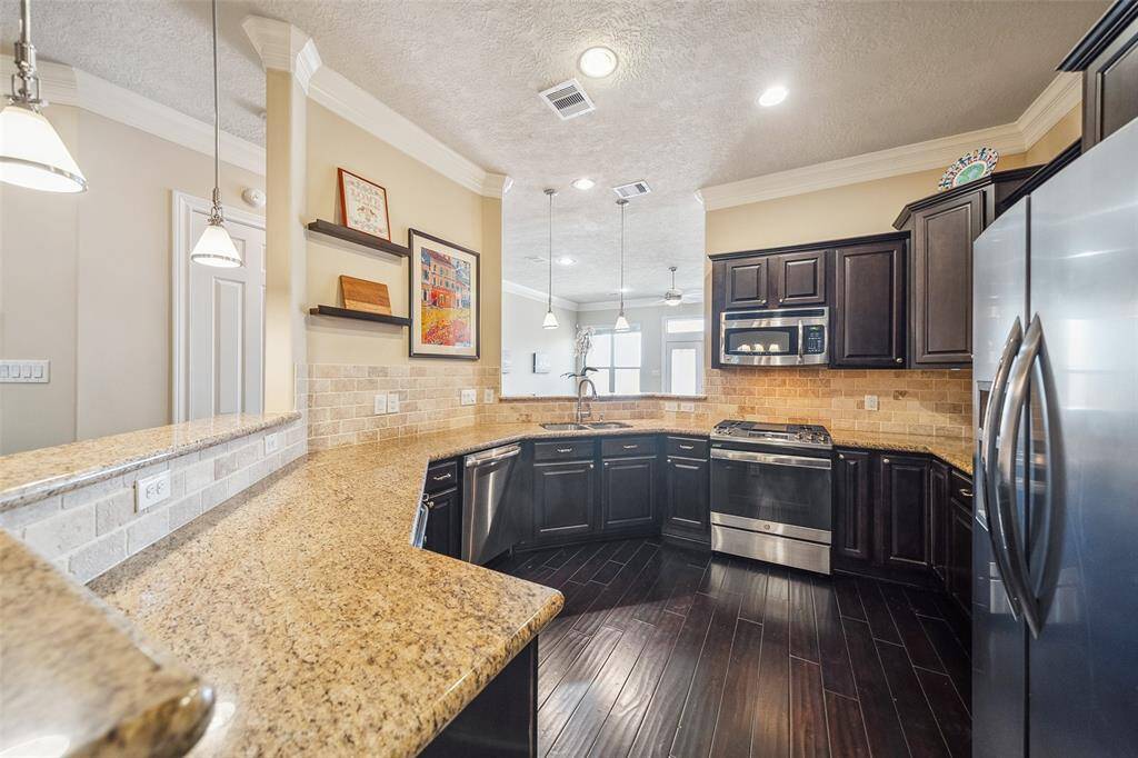 The kitchen has granite counters that go on for days, abundant cabinet storage, and stainless steel appliances.