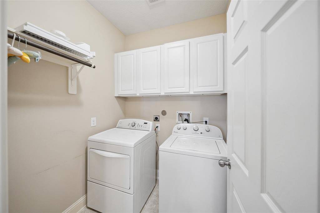 A spacious laundry room is located near the primary bedroom.