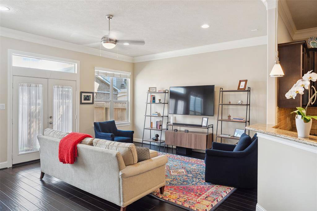 The living room gets tons of natural light from the wall of windows and is situated just off the kitchen. The breakfast bar makes this area great for entertaining.