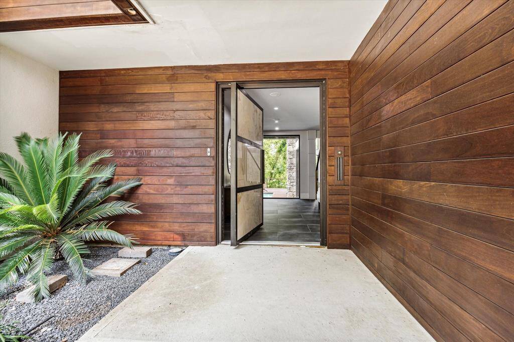 As you reach the front door, you are greeted by an onyx/steel front entrance with the door that lights up at night. This meticulously crafted entrance sets the tone for the rest of the house, offering a glimpse of the refined elegance and attention to detail that awaits inside.