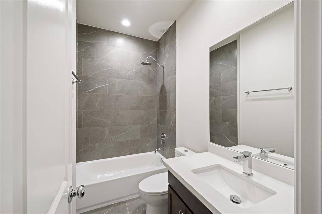 Modern half-bath featuring a pedestal sink, a wall-mounted mirror.