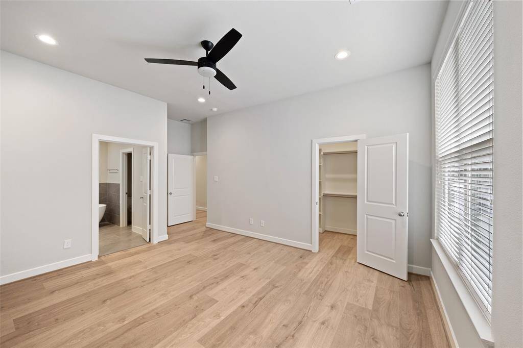 Spacious primary bedroom with walk-in closet.