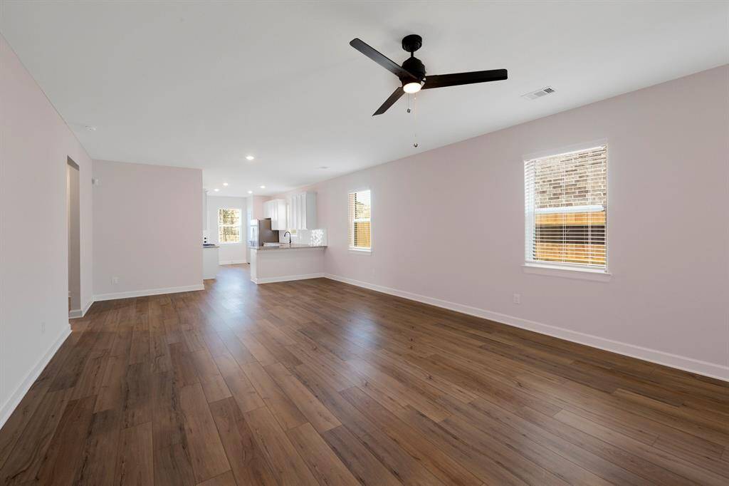 Look at the natural light and gorgeous vinyl plank floors in the living room.