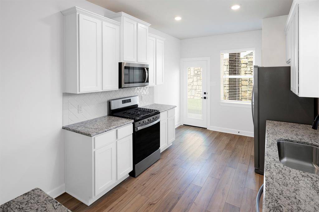 The kitchen cabinets are upgraded and painted, and the appliances are brand new, stainless steel, Whirlpool appliances.