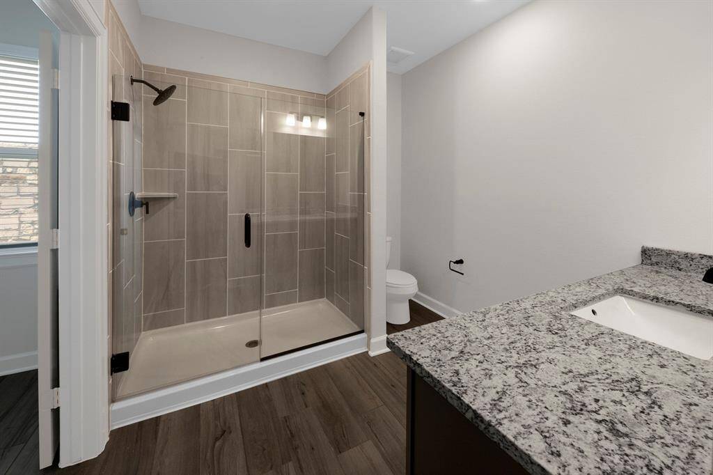 Imagine stepping into a spacious shower with upgraded fixtures. Beautiful!