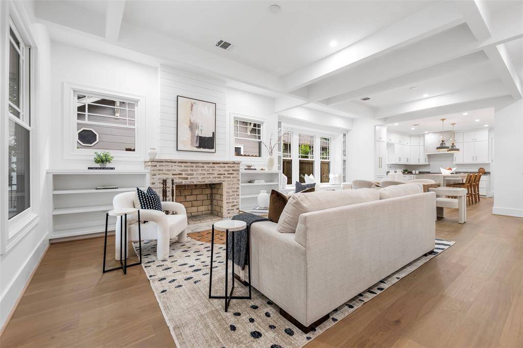 Open concept living featuring white oak hardwood and coffered ceilings in the living area