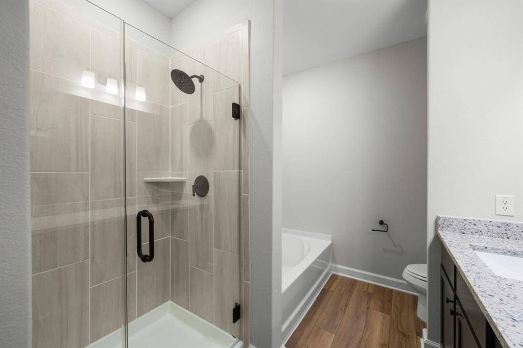Imagine stepping into a spacious shower with upgraded fixtures. Beautiful!