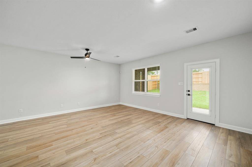 Look at the natural light and gorgeous vinyl plank floors in the living room.