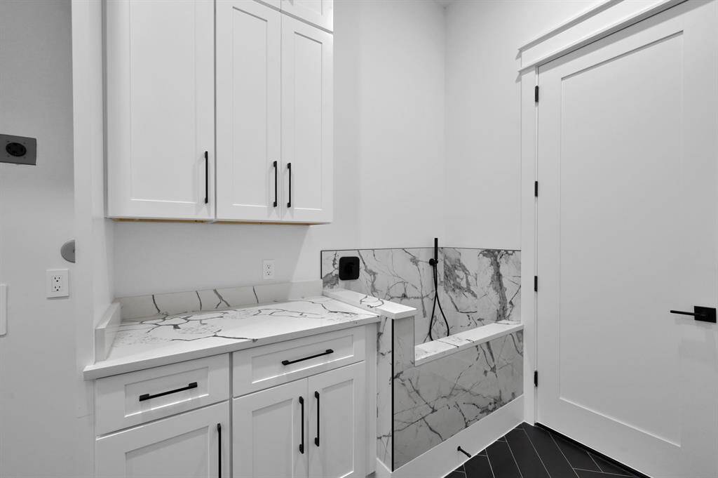 Custom dog shower at entrance from garage