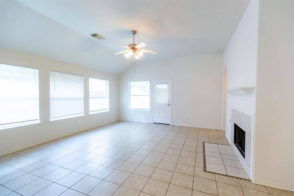 The living room is open and airy, with ample natural light from large windows. Ideal for relaxing and entertaining.