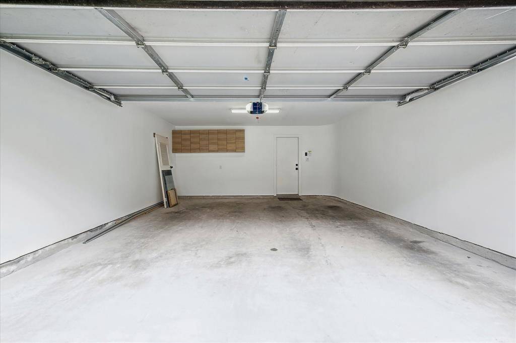 2 car garage with cabinet storage and entry to foyer space.