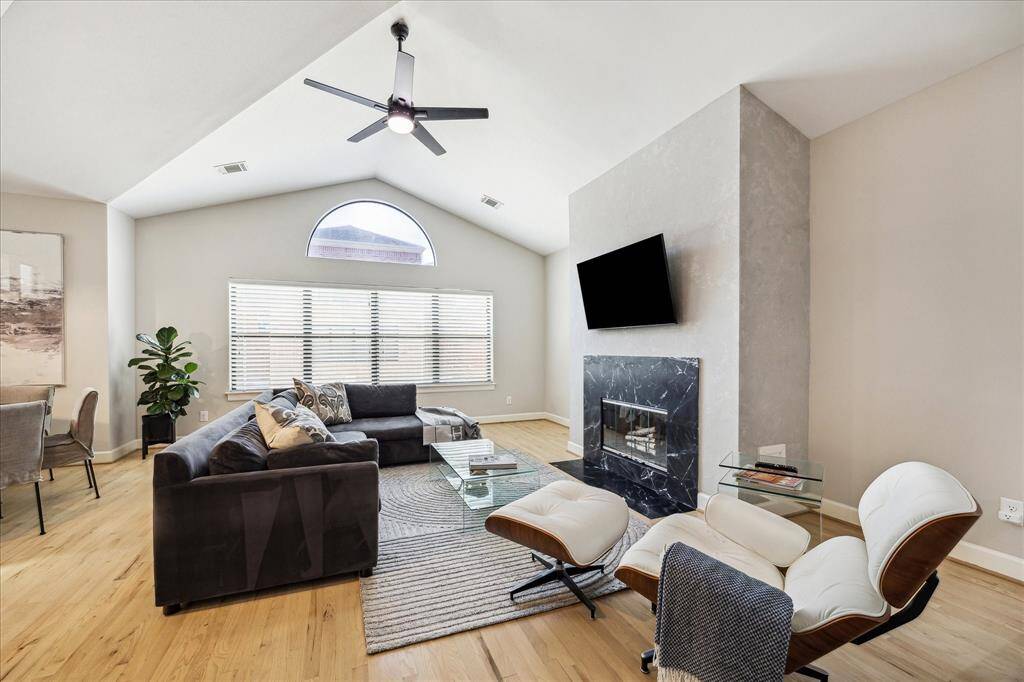 Second floor living space with vaulted ceiling and gas connection fireplace.