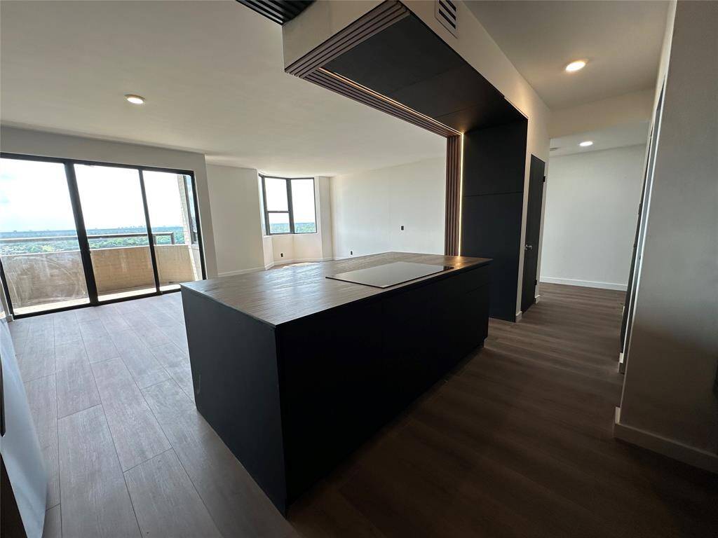 Floating kitchen island with electric stove top.