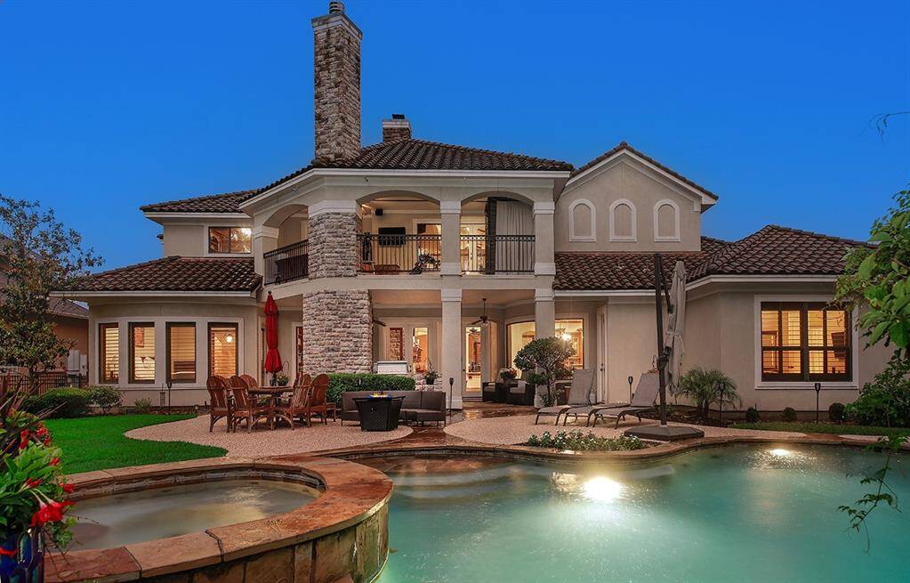 Enjoy the scenic backyard oasis with outdoor living and dining areas