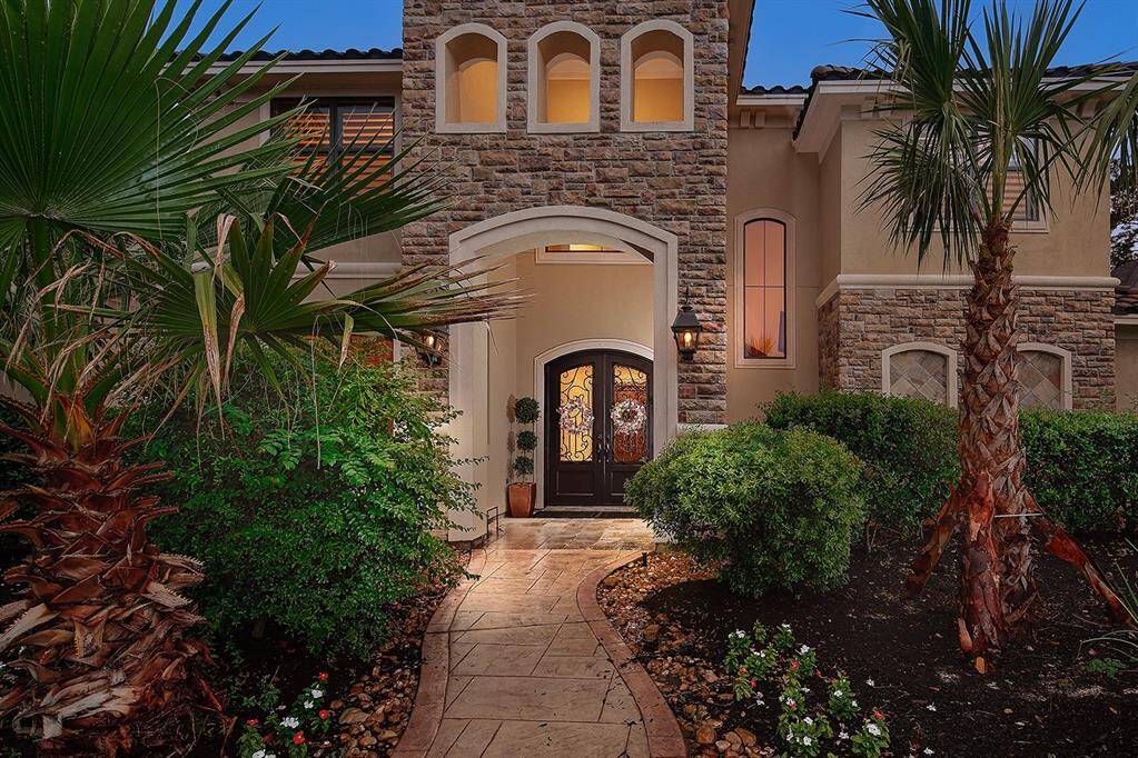 Welcoming front porch with stately, double arched entry doors
