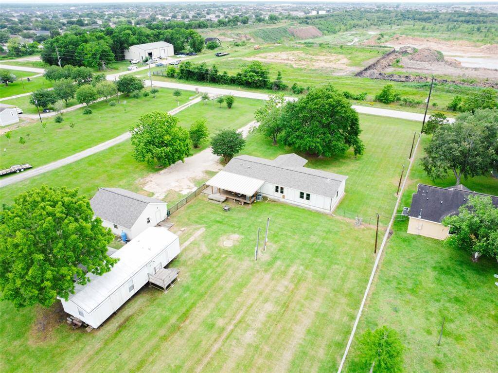 Two single family manufactured homes and country acreage with ample greenery & mature trees, offering privacy and open space.