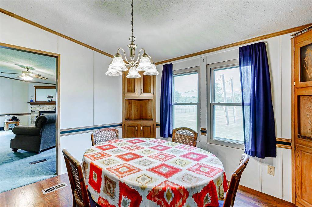 Enjoy the views of the outdoors from two large windows in this well lit dining space.