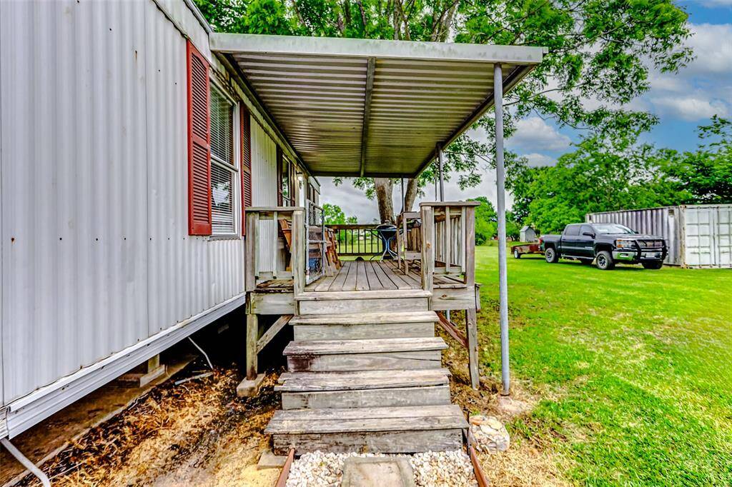 Complete with a covered porch offering a rustic, open-air feel.