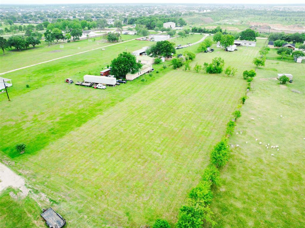 Another aerial view of this tree lined, well maintained acreage property.
