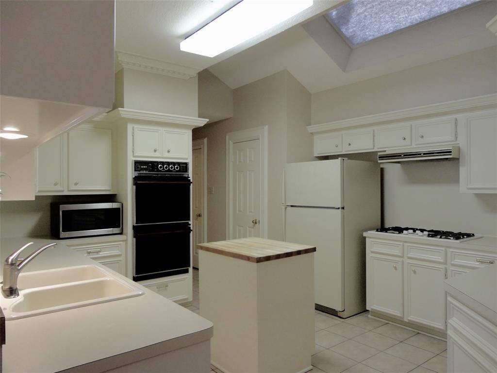 GAS COOK-TOP... DOUBLE OVENS... SERVICE ISLAND FOR PREP SPACE...