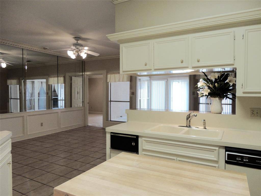 VIEW ACROSS KITCHEN/ BREAKFAST BAR... OF BREAKFAST ROOM... DOORWAY INTO MASTER... & SUN ROOM/ GAME ROOM...