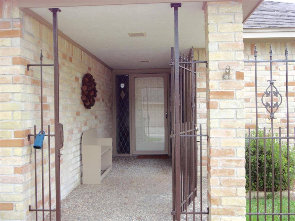 GATED ENTRY ... LEADS TO FRONT COVERED PORCH..
