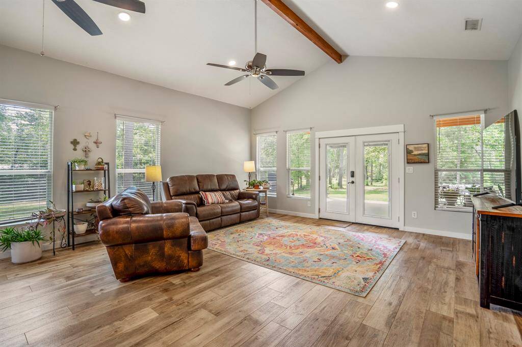 The room opens to the outdoors through a set of French doors, enhancing the connection with nature.