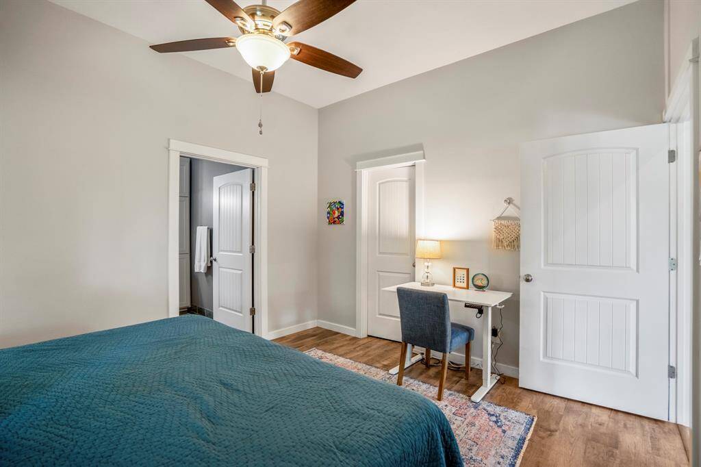 The primary bedroom features a walk in closet and space for a desk.